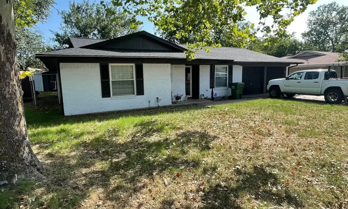 Professional roofing crew working on a residential roof in Jamestown